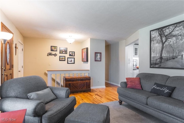 living area featuring baseboards and wood finished floors