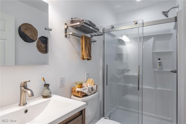 full bath featuring a shower stall, toilet, and vanity