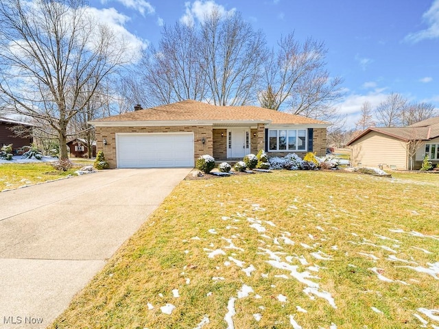 view of front of property with brick siding, an attached garage, driveway, and a front yard