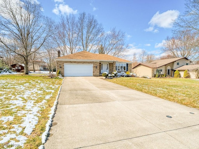 view of front of property featuring a chimney, concrete driveway, a front lawn, a garage, and brick siding