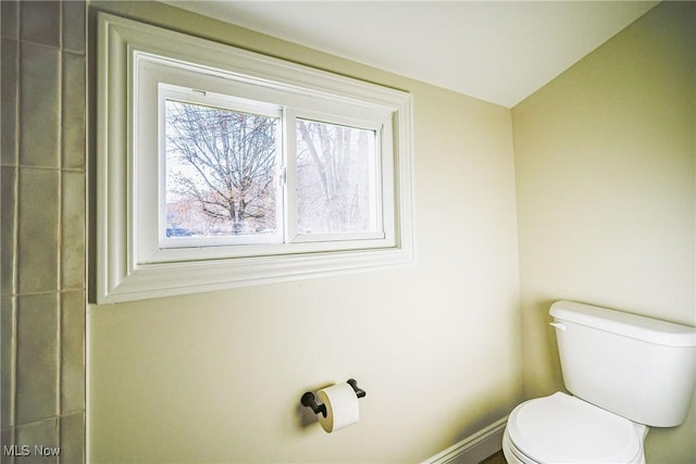 bathroom featuring toilet and baseboards