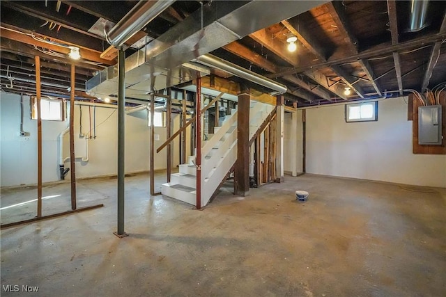 basement featuring electric panel and stairway