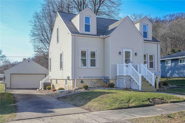 cape cod-style house with an outbuilding, a front lawn, a detached garage, cooling unit, and a shingled roof