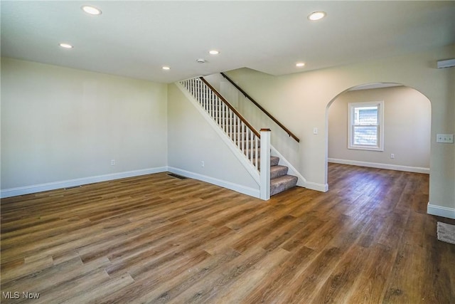 interior space featuring stairs, recessed lighting, wood finished floors, and baseboards