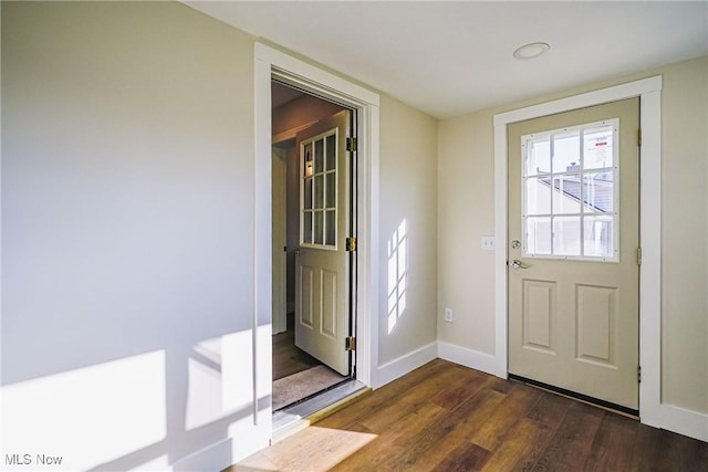 interior space featuring baseboards and dark wood-style flooring