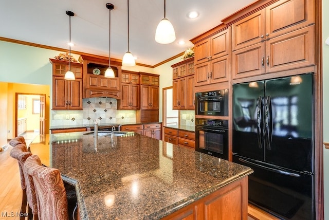 kitchen featuring black appliances, brown cabinets, and ornamental molding