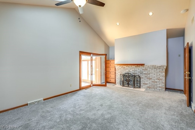 unfurnished living room featuring visible vents, high vaulted ceiling, carpet flooring, baseboards, and a brick fireplace