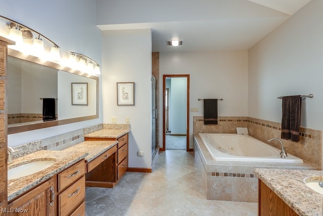 full bathroom with vanity, a tub with jets, baseboards, a stall shower, and tile patterned floors