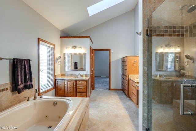 full bath with vanity, a shower stall, a skylight, and a jetted tub