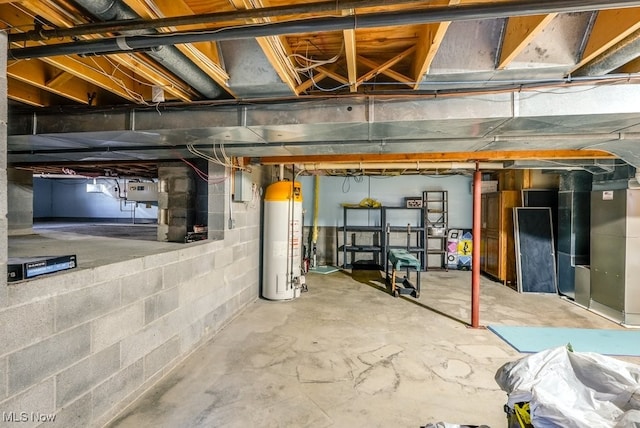 unfinished basement featuring electric panel, heating unit, and water heater