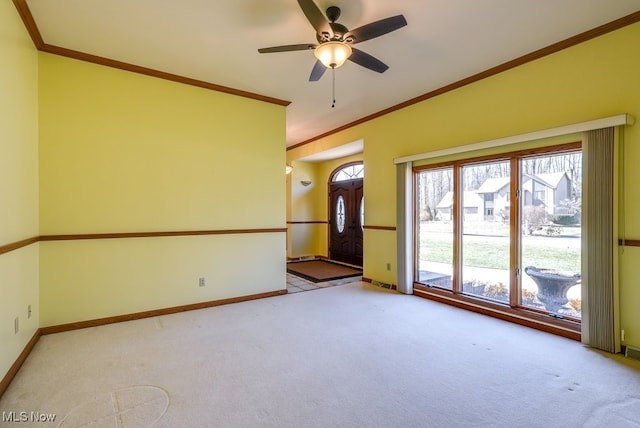 empty room with carpet flooring, ceiling fan, baseboards, and ornamental molding