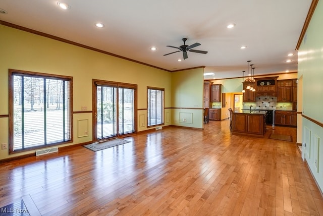 unfurnished living room featuring ornamental molding, recessed lighting, visible vents, and light wood-type flooring