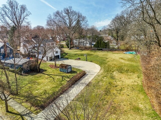 view of yard featuring a residential view and driveway