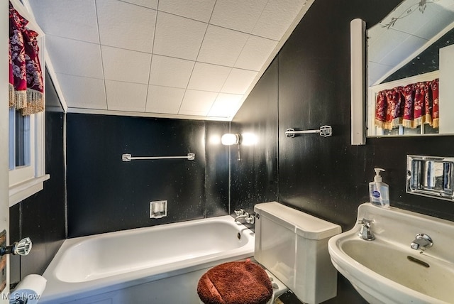 full bathroom featuring vaulted ceiling, toilet, shower / washtub combination, and a sink