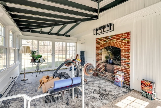 exercise room with lofted ceiling, carpet floors, and a baseboard radiator