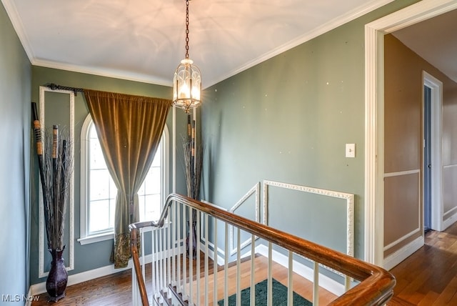 stairs featuring ornamental molding, baseboards, and wood finished floors