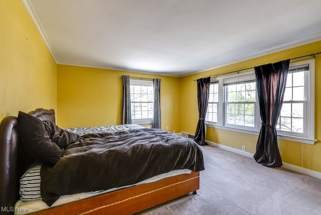 carpeted bedroom featuring baseboards and ornamental molding