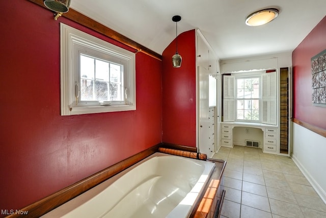 full bathroom featuring tile patterned floors, visible vents, a bath, and baseboards