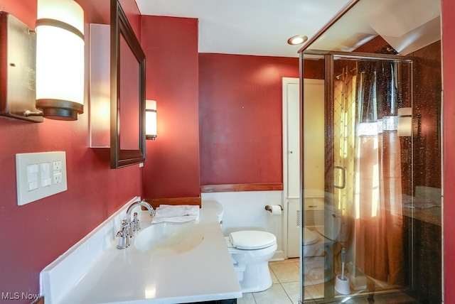 full bath with tile patterned flooring, toilet, vanity, and a stall shower