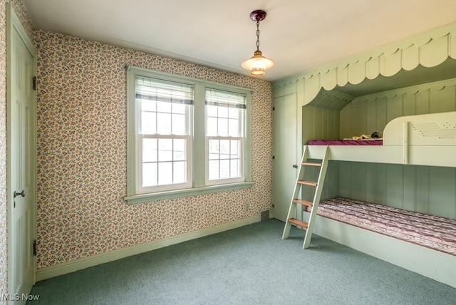 bedroom featuring wallpapered walls, carpet, and baseboards