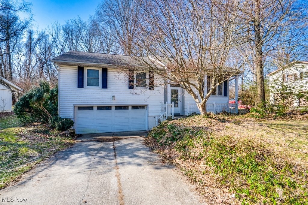 split foyer home featuring a garage and driveway