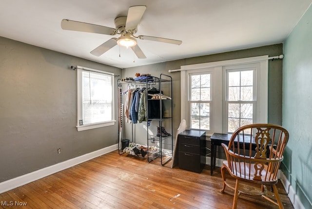 bedroom featuring hardwood / wood-style flooring, a ceiling fan, and baseboards