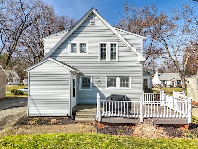 back of house featuring a wooden deck