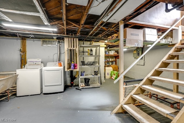 unfinished basement featuring washer and dryer and stairway