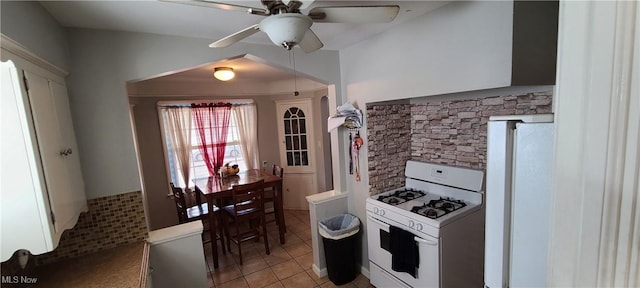 kitchen featuring white appliances, light tile patterned floors, and a ceiling fan