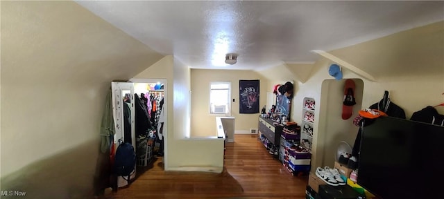 additional living space with lofted ceiling and wood finished floors