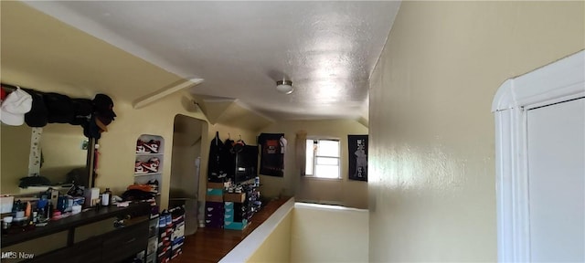 hallway featuring vaulted ceiling