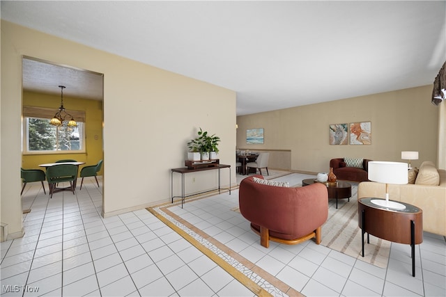 living area featuring a chandelier, baseboards, and light tile patterned flooring