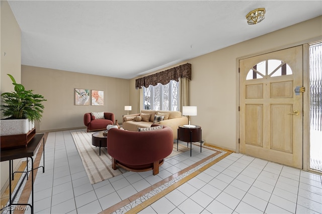 foyer featuring light tile patterned floors and baseboards