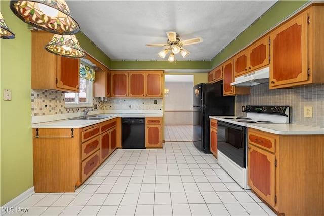 kitchen featuring black appliances, light tile patterned flooring, light countertops, and under cabinet range hood