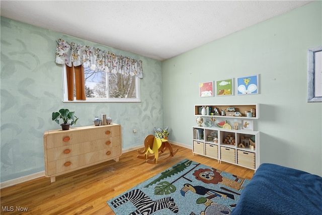 interior space with wood finished floors and baseboards