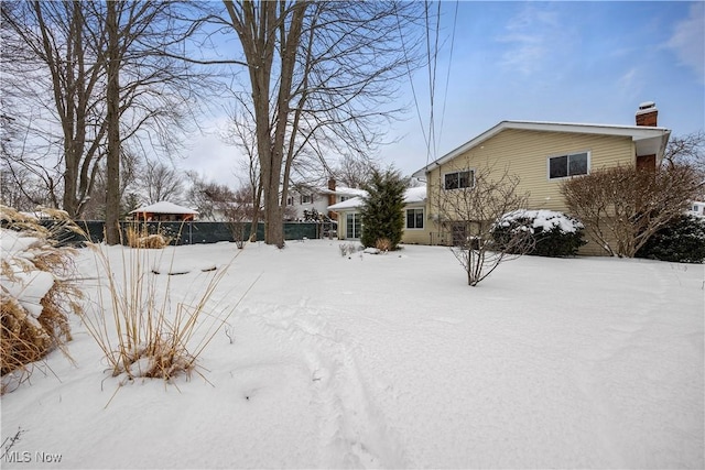 yard layered in snow with fence