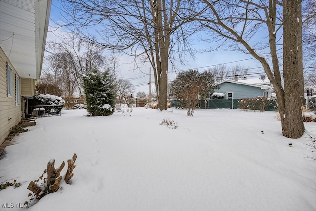 snowy yard with fence