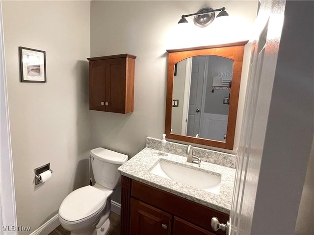 bathroom featuring toilet and vanity