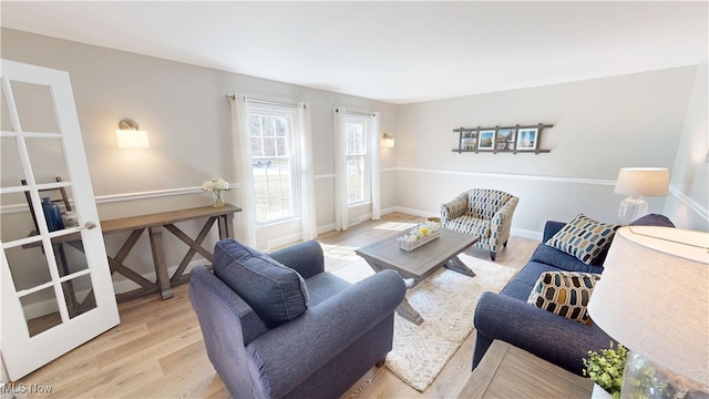 living room featuring baseboards and wood finished floors