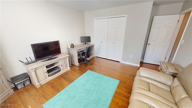 living room featuring baseboards and wood finished floors