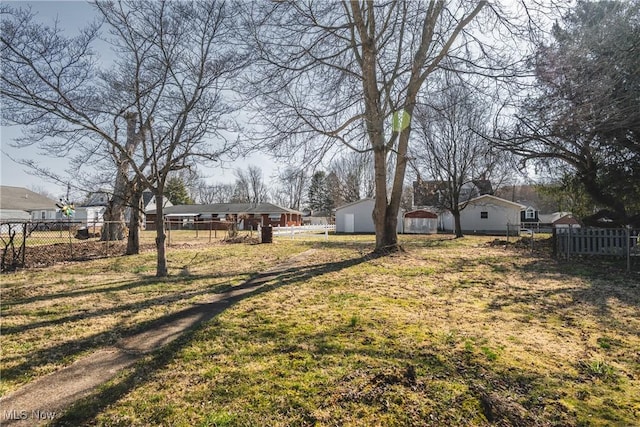 view of yard with an outdoor structure and fence