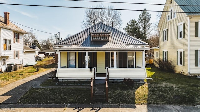 bungalow-style house featuring covered porch and metal roof