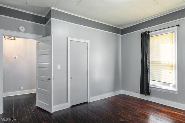 unfurnished bedroom with ornamental molding, baseboards, and hardwood / wood-style floors