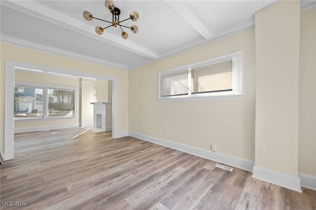 unfurnished living room featuring beam ceiling, a fireplace, baseboards, and wood finished floors