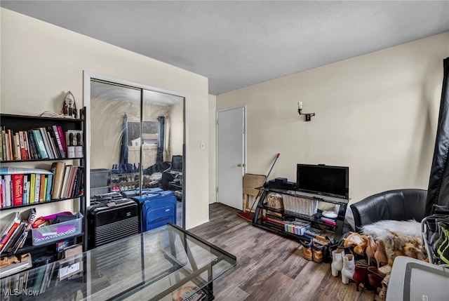 office area with wood finished floors and a textured ceiling