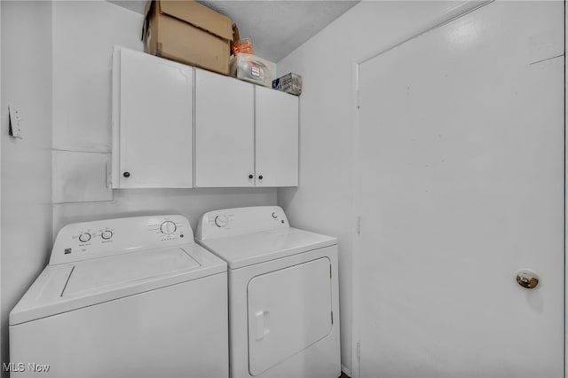 washroom featuring cabinet space and independent washer and dryer