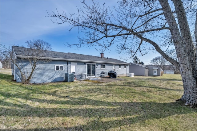 back of house with a patio area, central air condition unit, and a yard