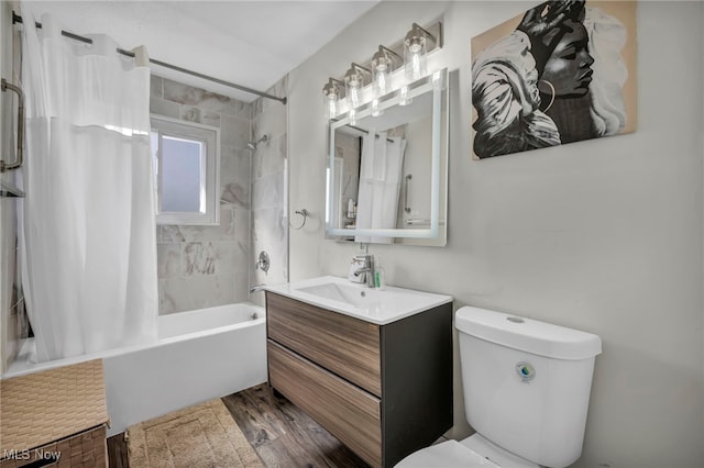 bathroom with toilet, wood finished floors, vanity, and shower / bath combination with curtain