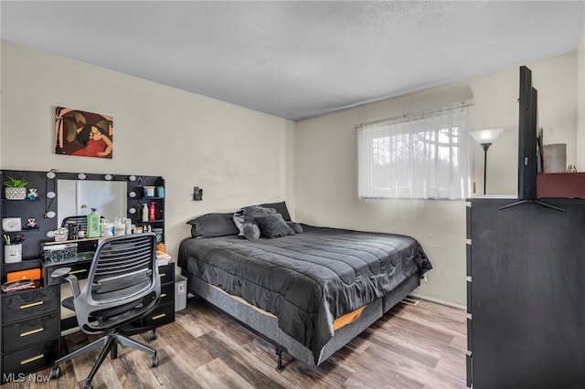 bedroom featuring wood finished floors