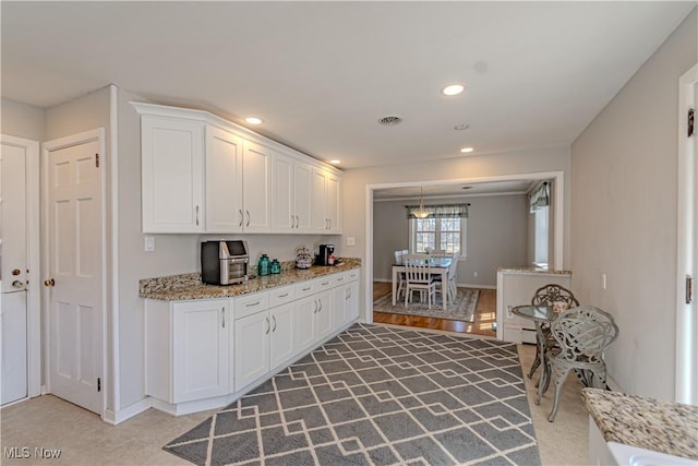 3164 Old Weymouth Rd, Medina, OH 44256 - kitchen with white cabinets, visible vents, light stone counters, and recessed lighting